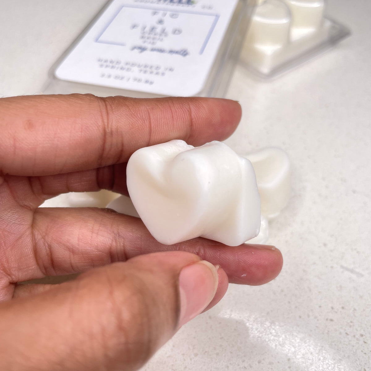 Fig & Field Soy Wax Melts in a plastic clamshell container heart shaped with earthy scents of fresh grass, fig, and basil for a calming ambiance. Breathe Well Aromatherapy